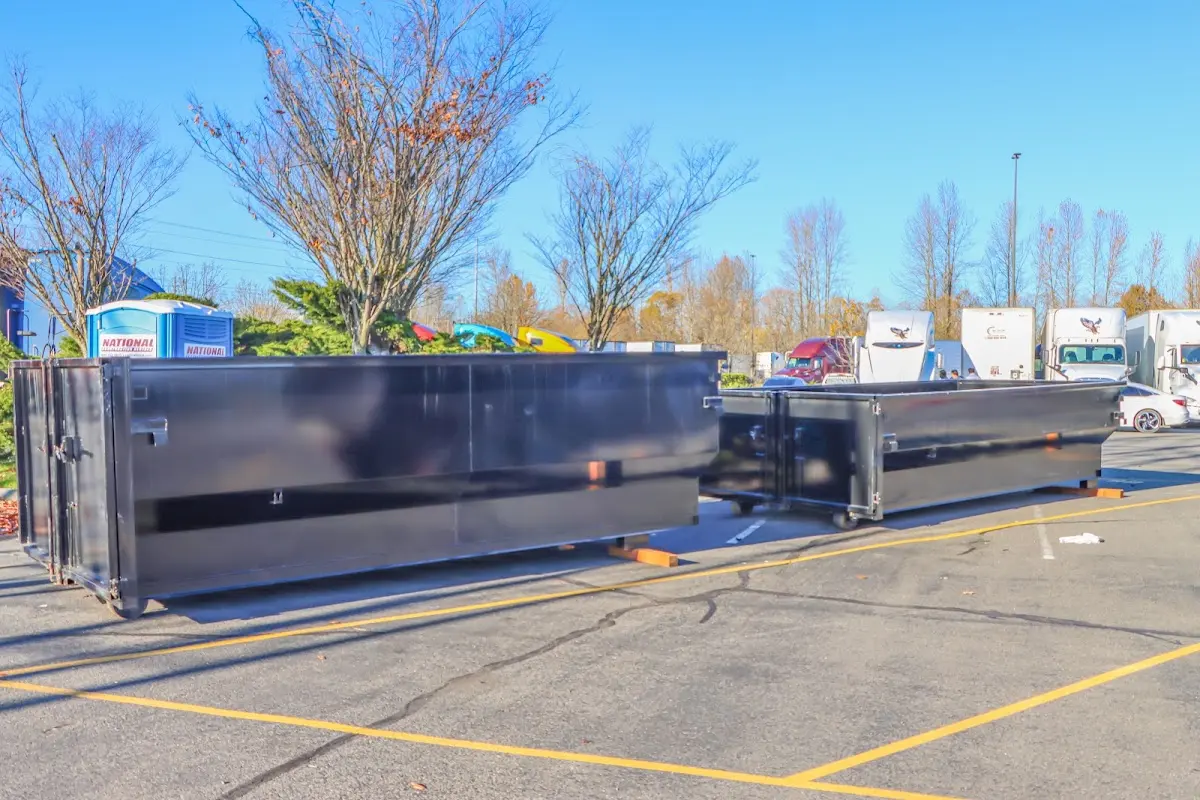 Professional dumpster rental service with roll-off container on residential driveway in Fulshear